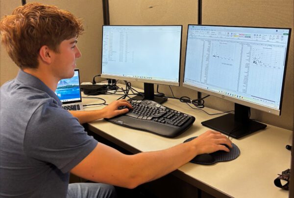 Ben Brenner sitting at a desk working on a his computer
