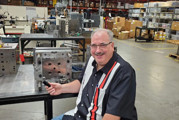 Brad Raker sitting in the shop in front of a mold.
