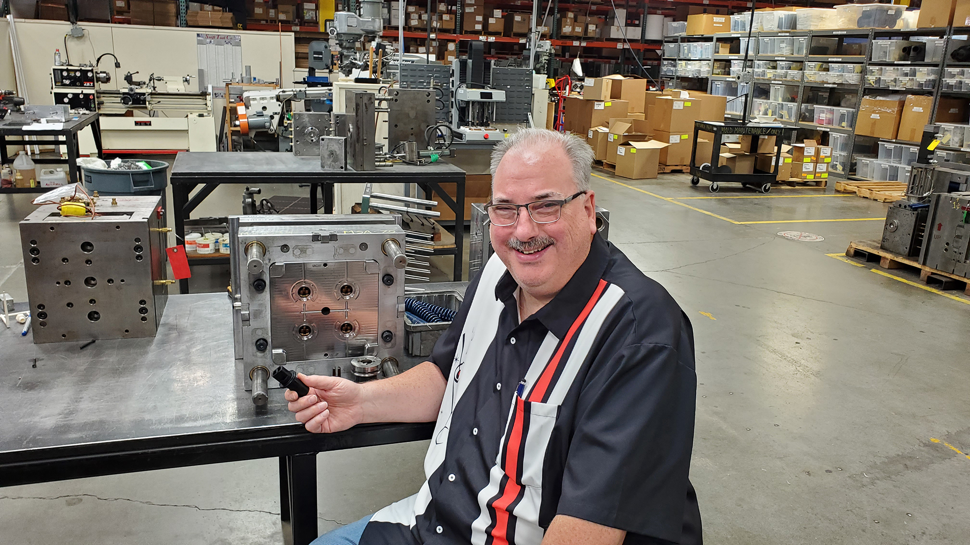 Brad Raker sitting in the shop in front of a mold.