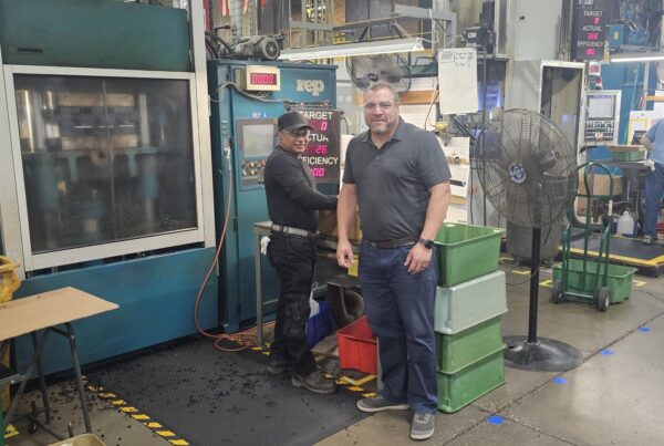 Kyle Kopp with another employee on the shop floor