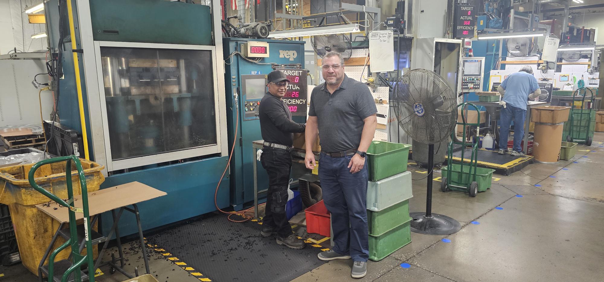 Kyle Kopp with another employee on the shop floor